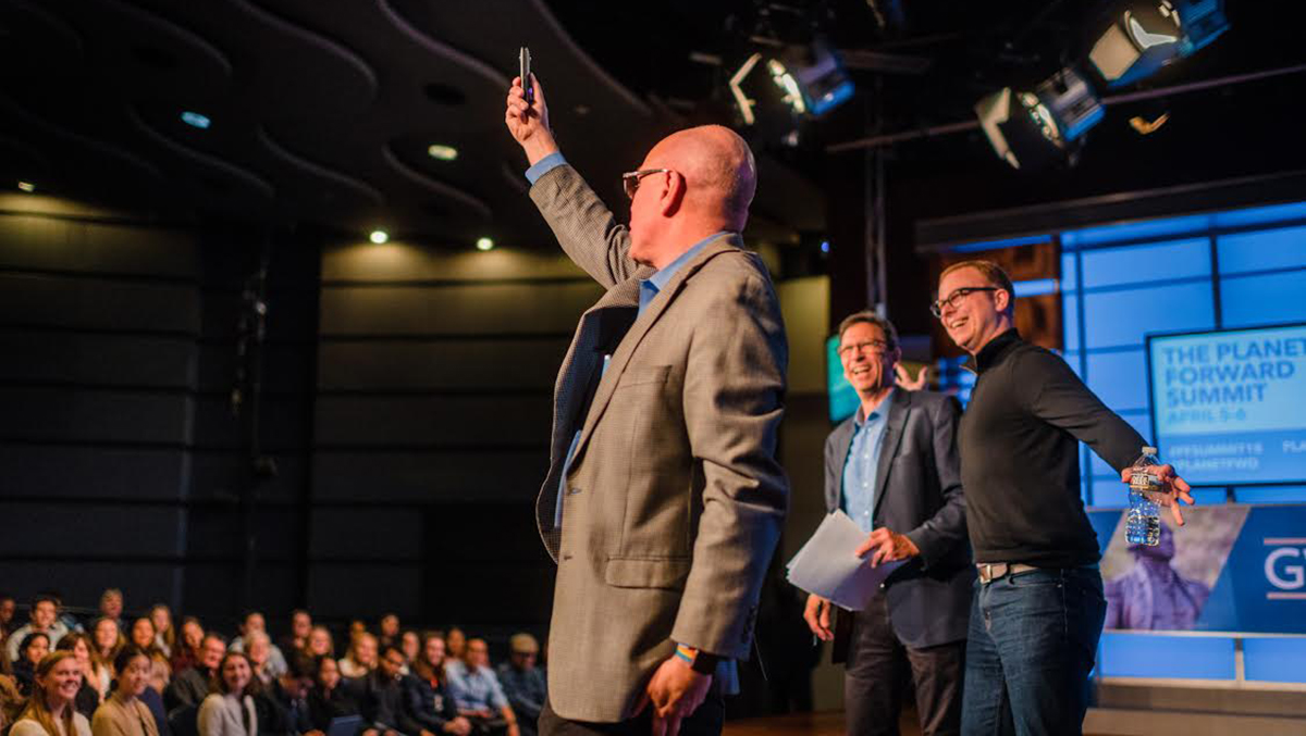 Adobe&#039;s Stephen Hart takes a 360-degree photo from the stage with Steve Johnson and Frank Sesno hamming it up.