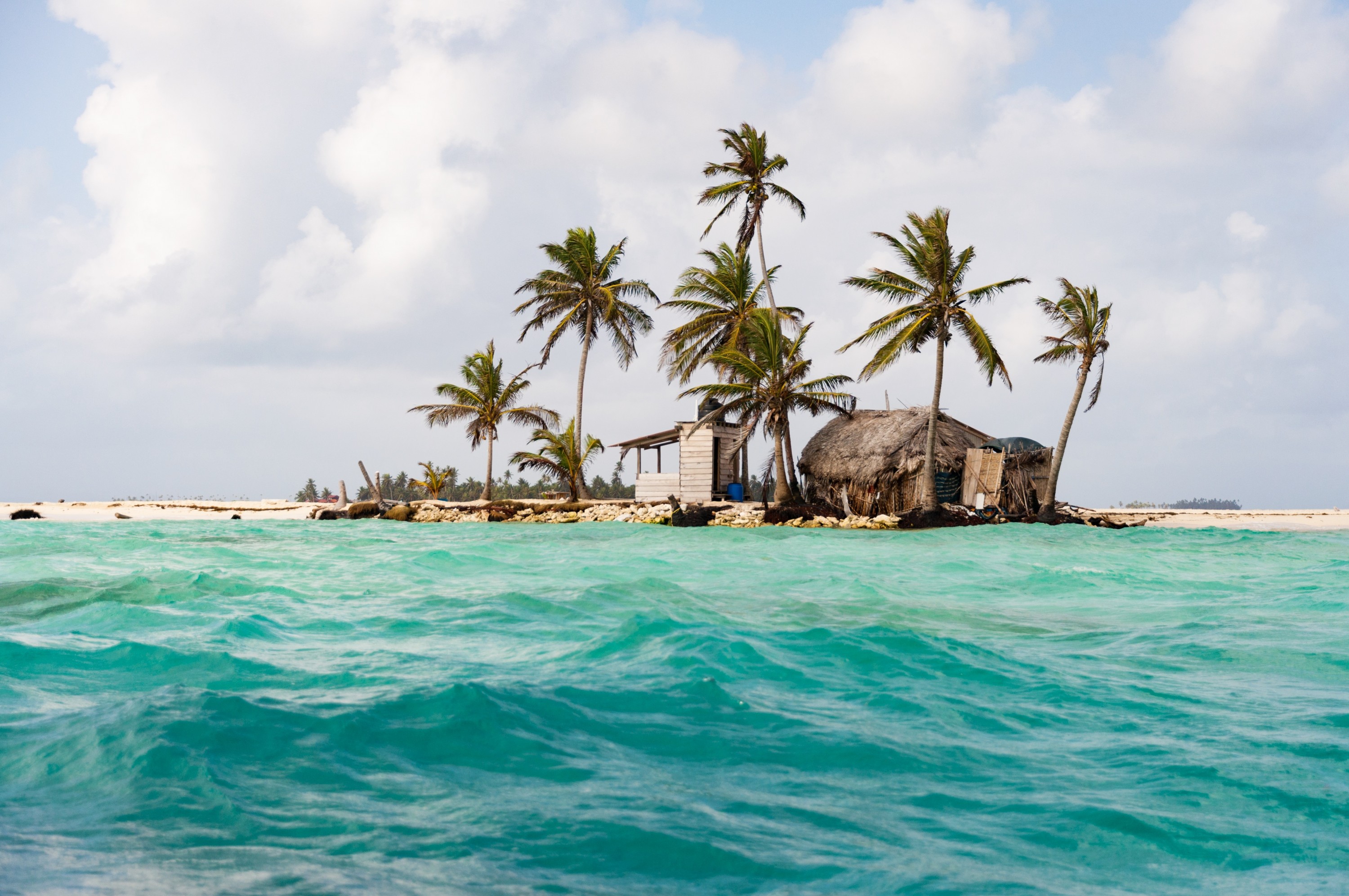 On approach, Pelican Island seems largely barren but for a few palm trees, two huts and a bathroom structure (at left). To tourists, it looks like a fantasy: a tiny castaway island to spend the day on. But for Davies and his mother, it’s home…and it’s shrinking.