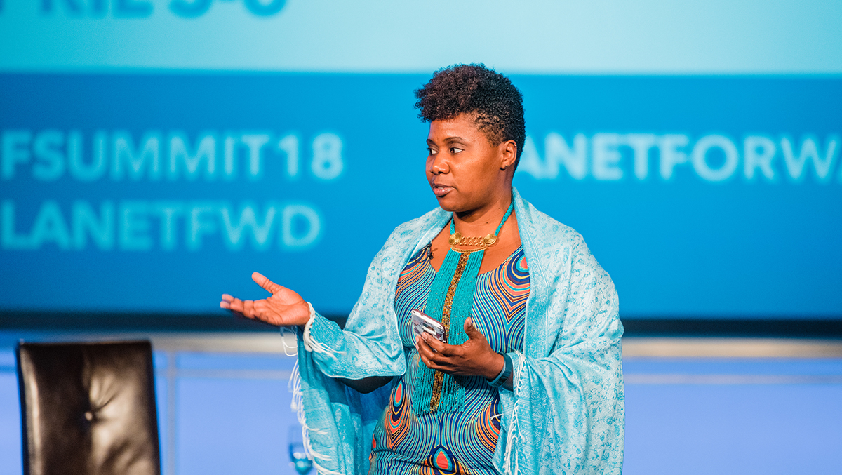 Dr. Imani M. Cheers, the Summit co-host, introduces the visual journalists from National Geographic for their Eyes on Earth presentation.