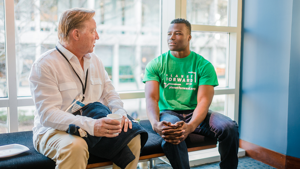 Planet Forward Advisory Board Member and University of Arizona professor Jim Buizer speaks with Eloka Obi, a statistics and environmental studies major at The George Washington University. The two networked at last year&#039;s event and were catching up.
