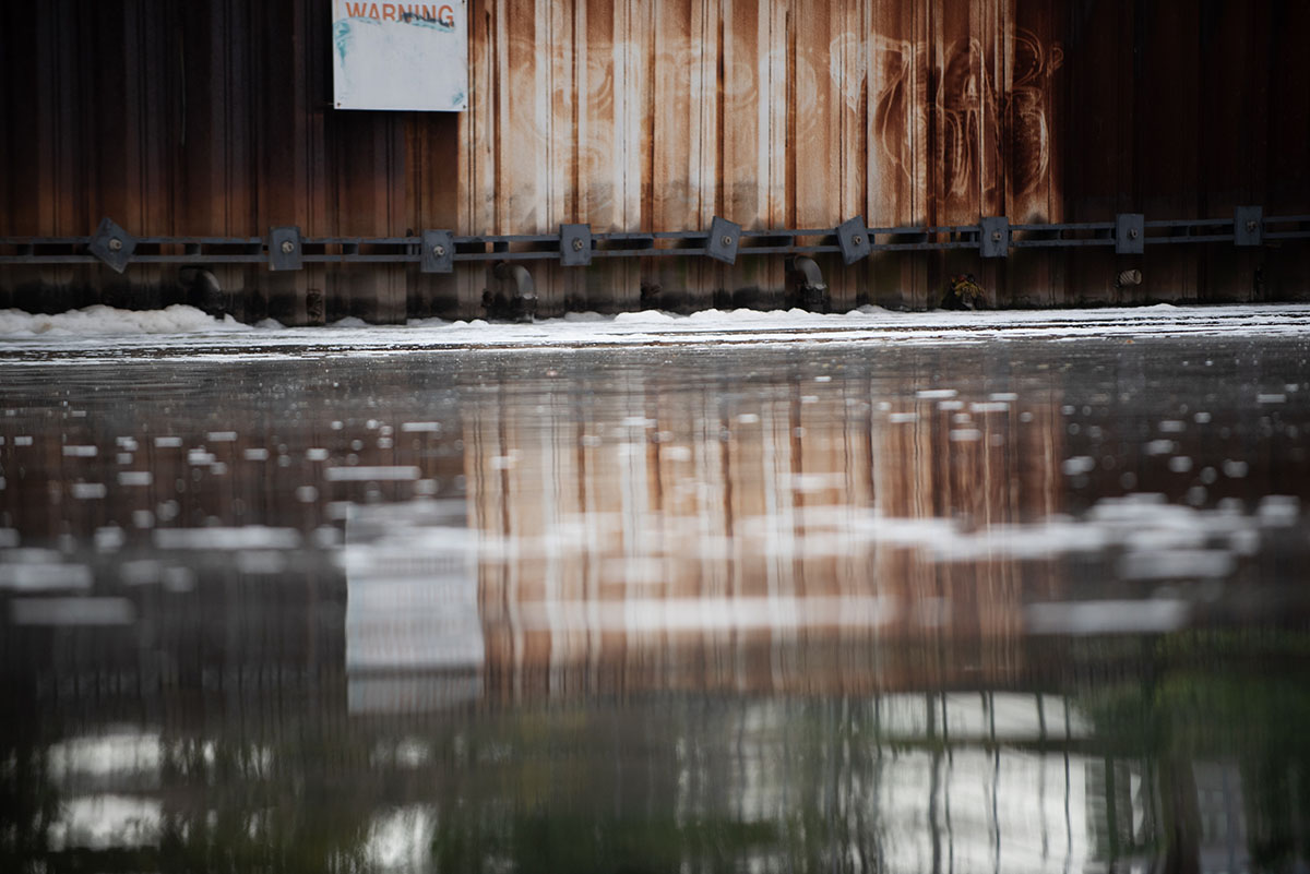 The Chicago River at the Webster Avenue Instream Aeration Station, which is designed to aerate river water to enhance the aquatic environment, improve and protect fish populations and prevent odors according to its sign.