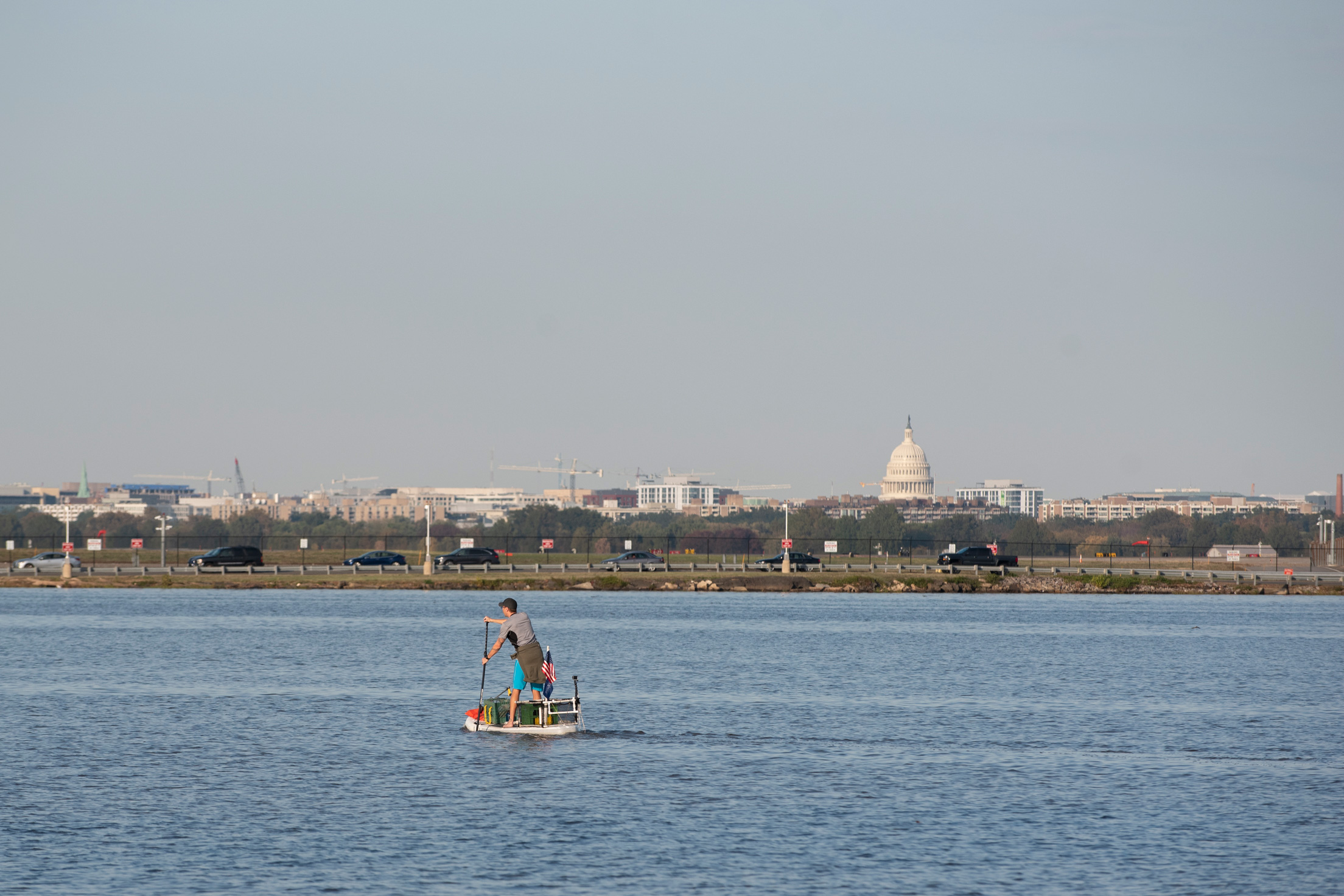 The United States Capitol Building is seen from a distance as Joseph Wright paddles down the Potomac River on November 5, 2019 in Alexandria, VA.