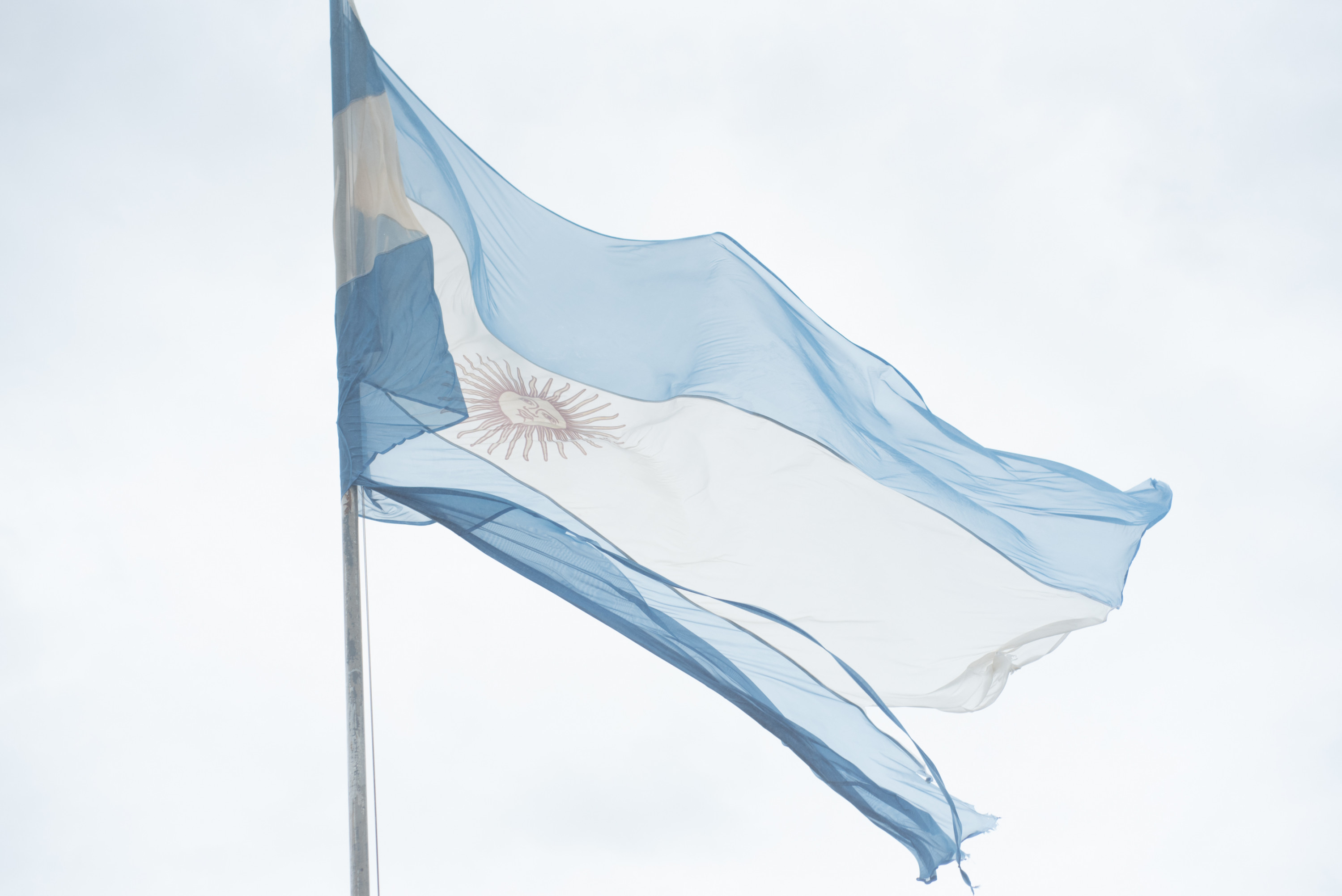 The Argentine flag waves in the misty air near the Devil’s Throat on the Argentine side.