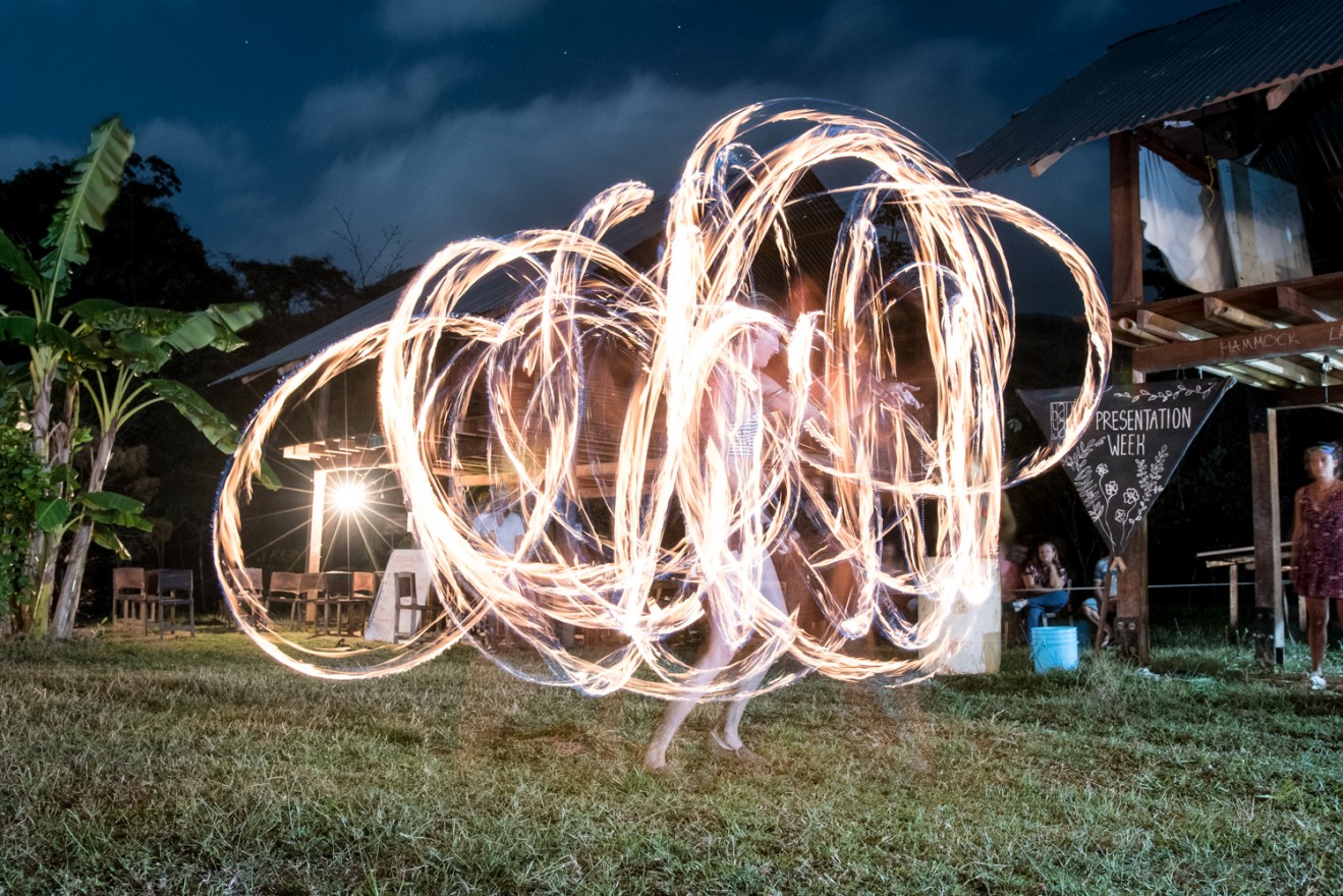Kalu Yala president Tara McLaughlin dances with fire during the Institute&#039;s &quot;Jungle Prom&quot; at the end of the spring semester.