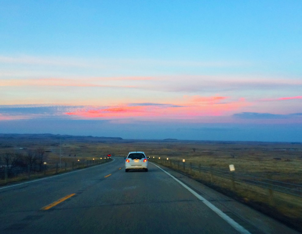 Travel to the River: Cotton candied clouds hung lazily above us with a color so vibrant it must have been painted by the imagination of a child. Fluorescent pinks, purples and oranges of every shade danced across the clouds from the horizon. Every mile was traversed in anticipation as the burial ground drew ever nearer.  (Photos by Alexandrea Rager)