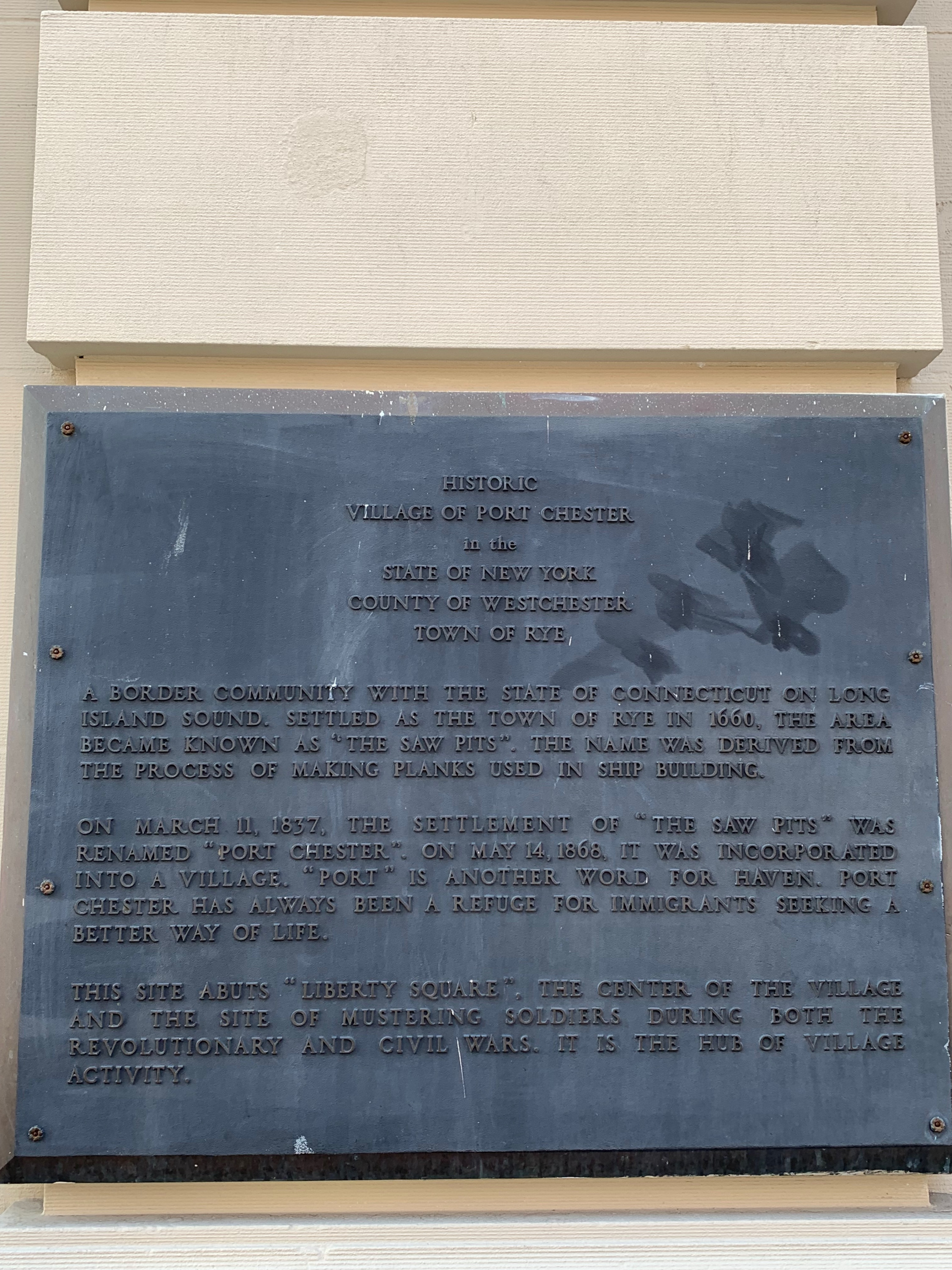 A plaque signifying the importance Port Chester has in welcoming immigrants as part of its community. Many are at risk of displacement because of development.