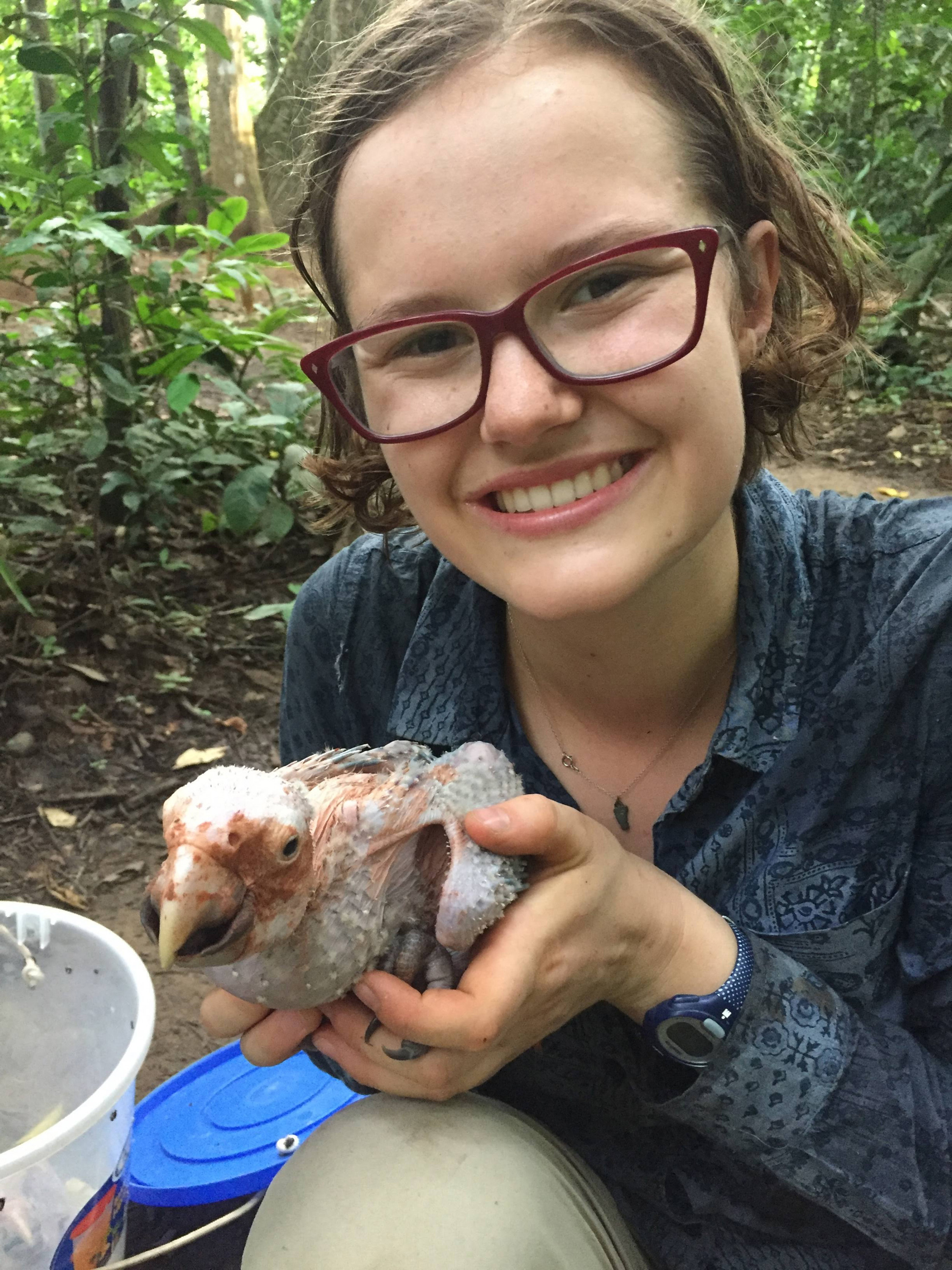 The author with a macaw chick. (Photo courtesy Greta Hardy-Mittell/Carleton College)