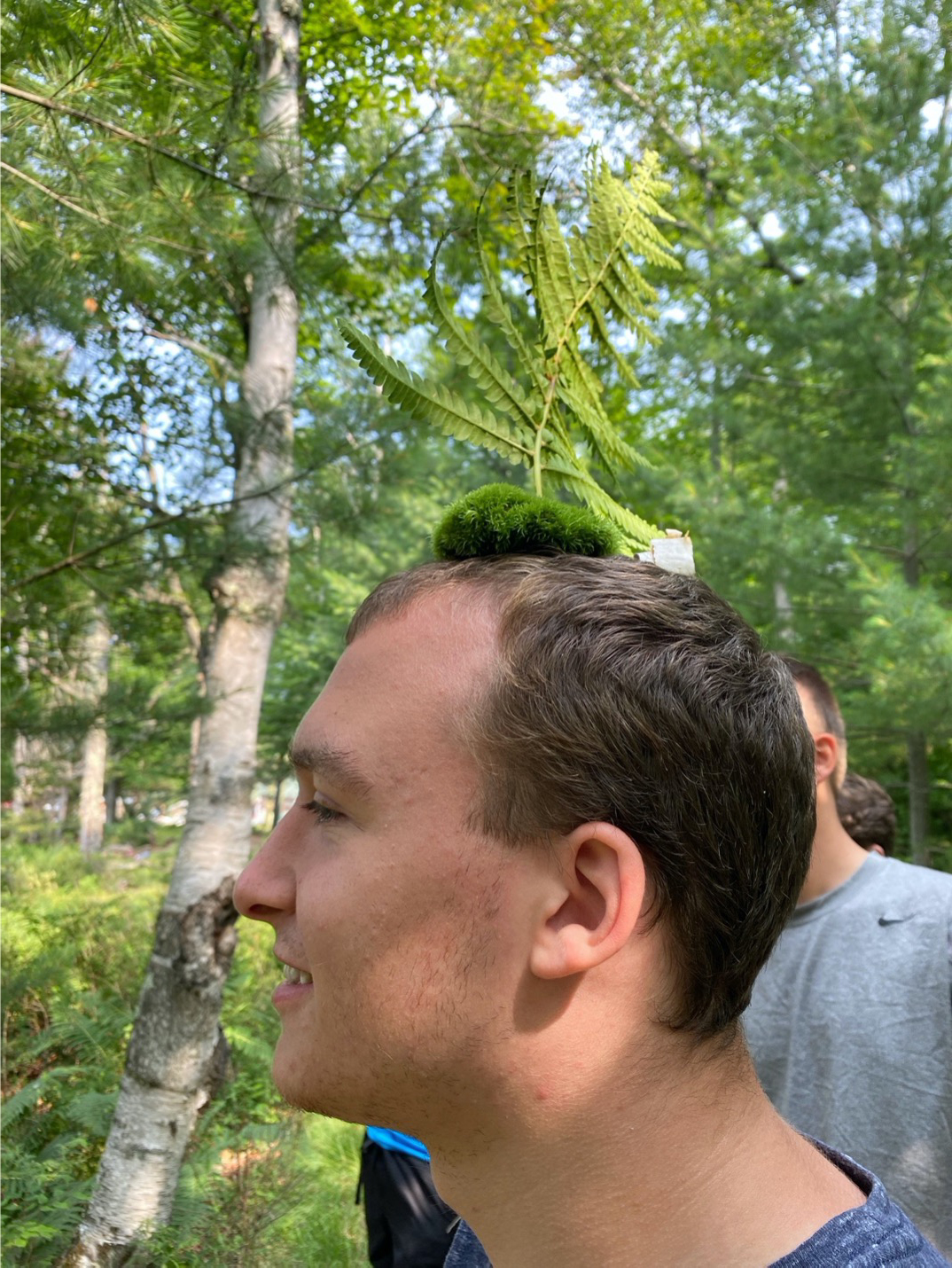 A student wearing a cap made of specimens they are learning as they walk.