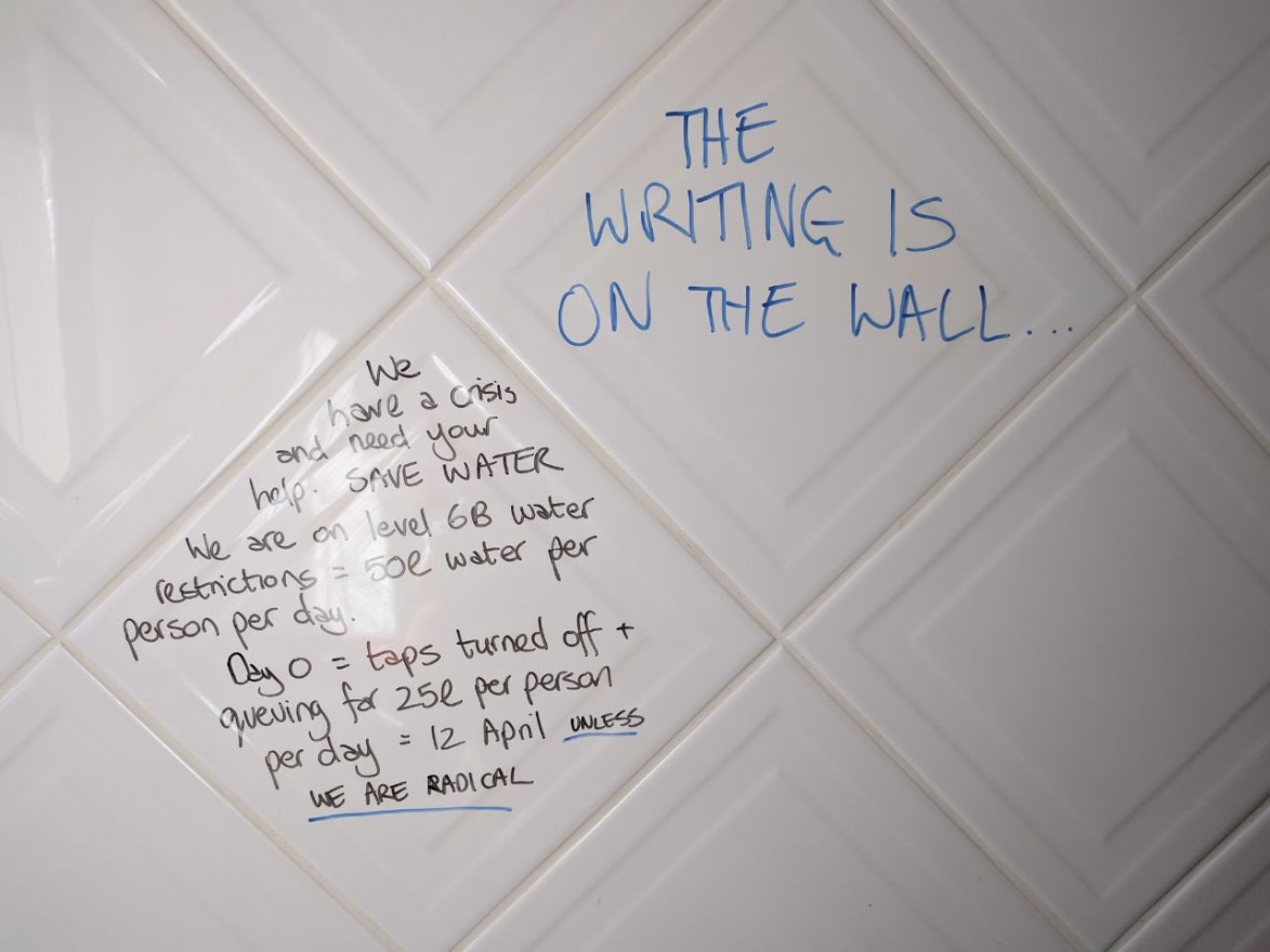 Bathroom &quot;graffiti&quot; urging people to save water.