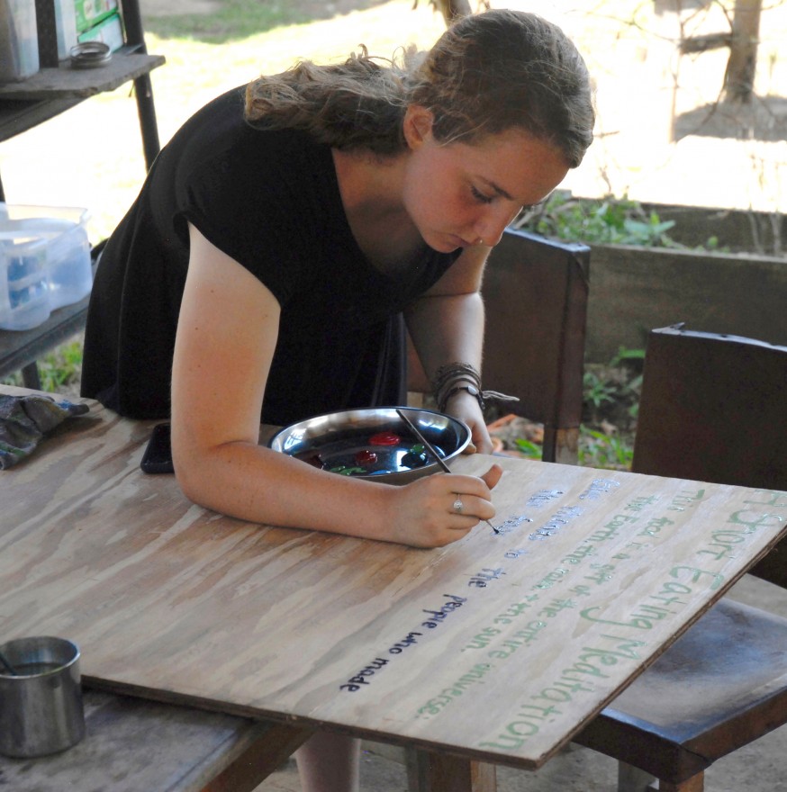 Diamond begins painting the final product of her mindful eating project, a sign to hang at Kalu Yala for future interns and residents to consider.