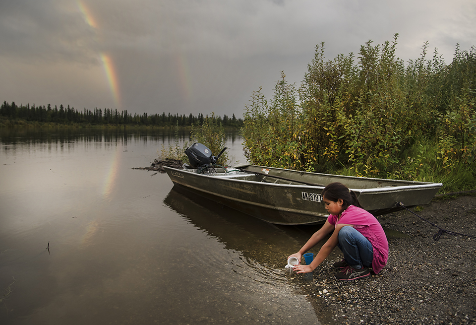 A young girl in the Alaskan village of Shungnak plays in the Kobuk river after a storm. (Jayme Dittmar/University of Montana)