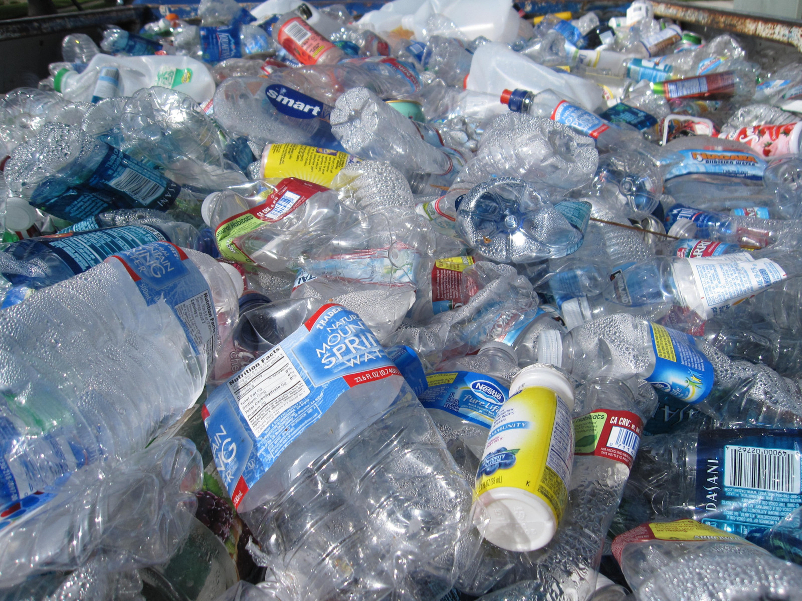 A pile of plastic bottles and packaging fills the frame.