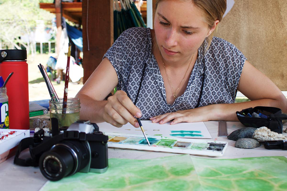 Student works on final design plan at Kalu Yala