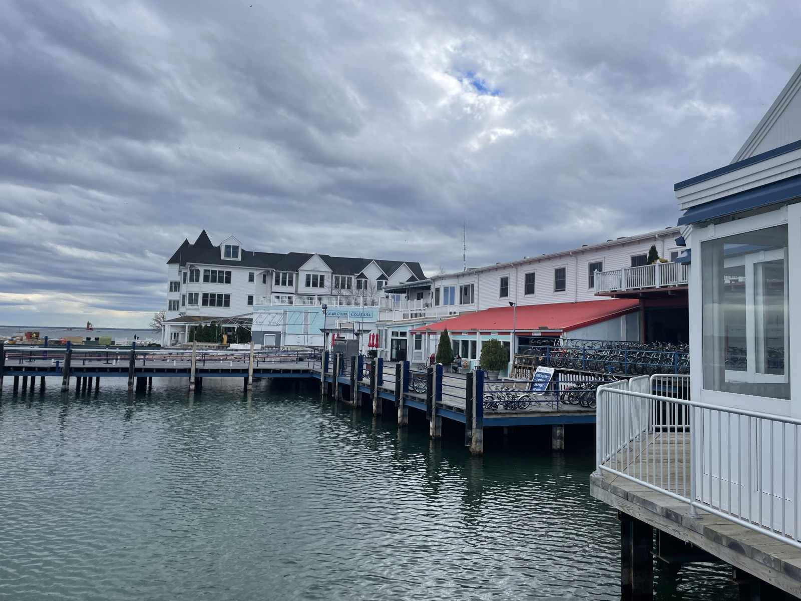View of a boardwalk, with several wide-sided building on the coast line.