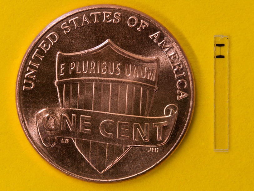 A superconducting qubit used for quantum sensing sits next to a U.S. penny.